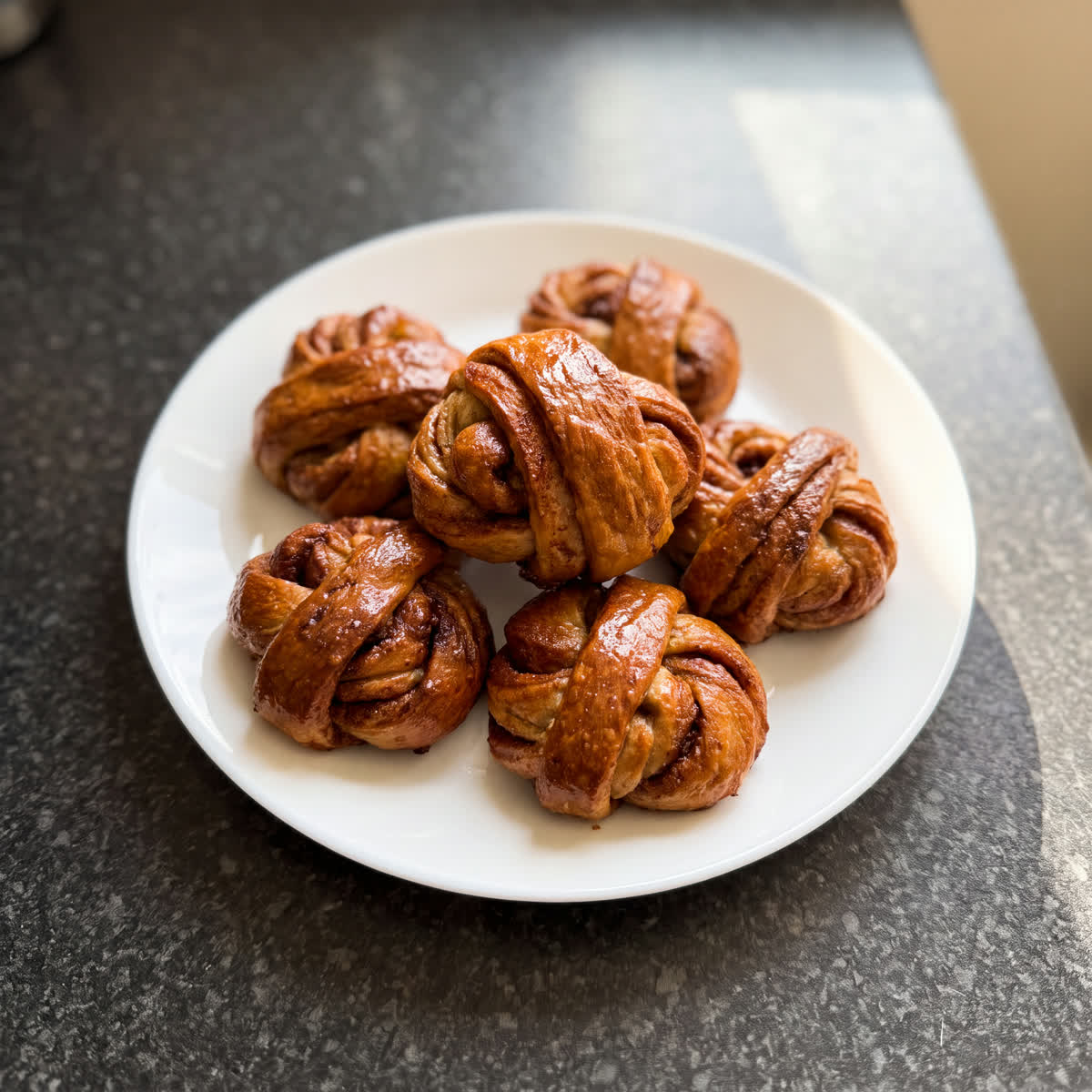 Hand-twisted cinnamon buns, thickly spiced and proved to a deep golden brown