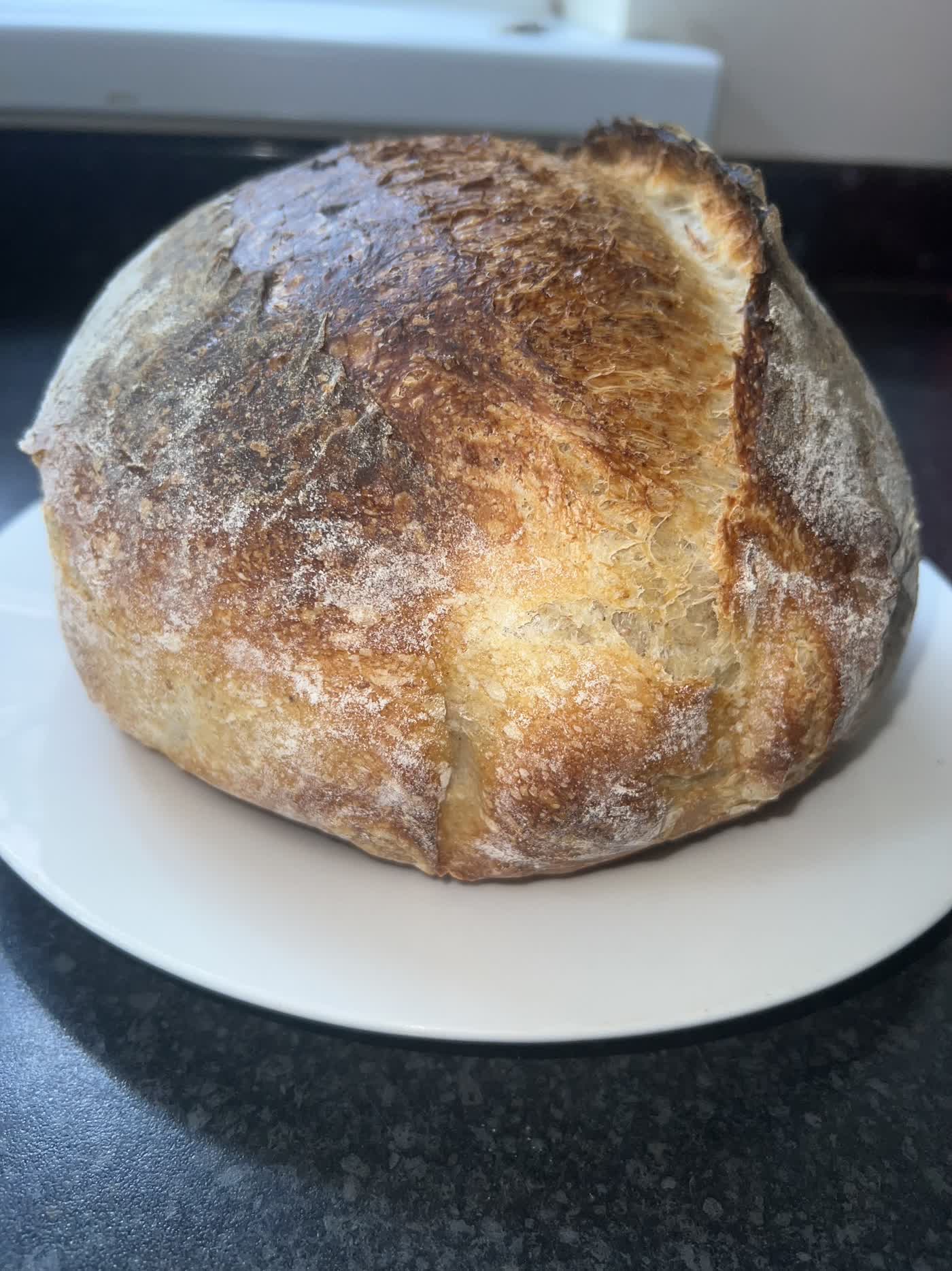 A round sourdough country loaf with a scored, crackling crust, baked by hand in Medway, Kent
